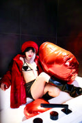 Person in a red outfit with large red balloons in a dark room